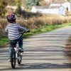 Riding a bicycle on a country road concept for healthy lifestyle, exercising and road safety