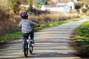 Riding a bicycle on a country road concept for healthy lifestyle, exercising and road safety