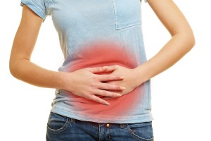 Young woman with adombinal pain and stomach cramps